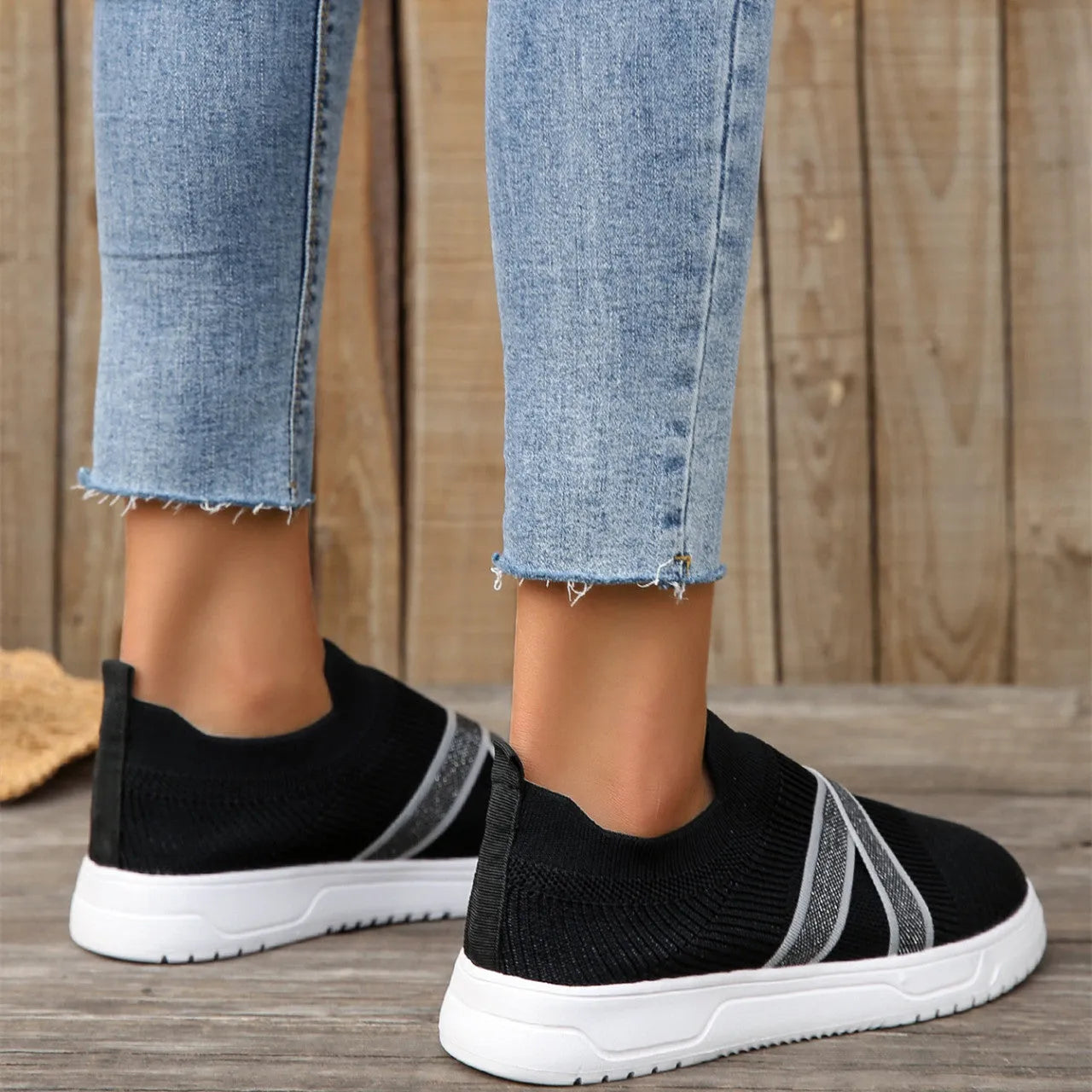 Black women's flyknit mesh shoes with flat rubber sole and tassel detail