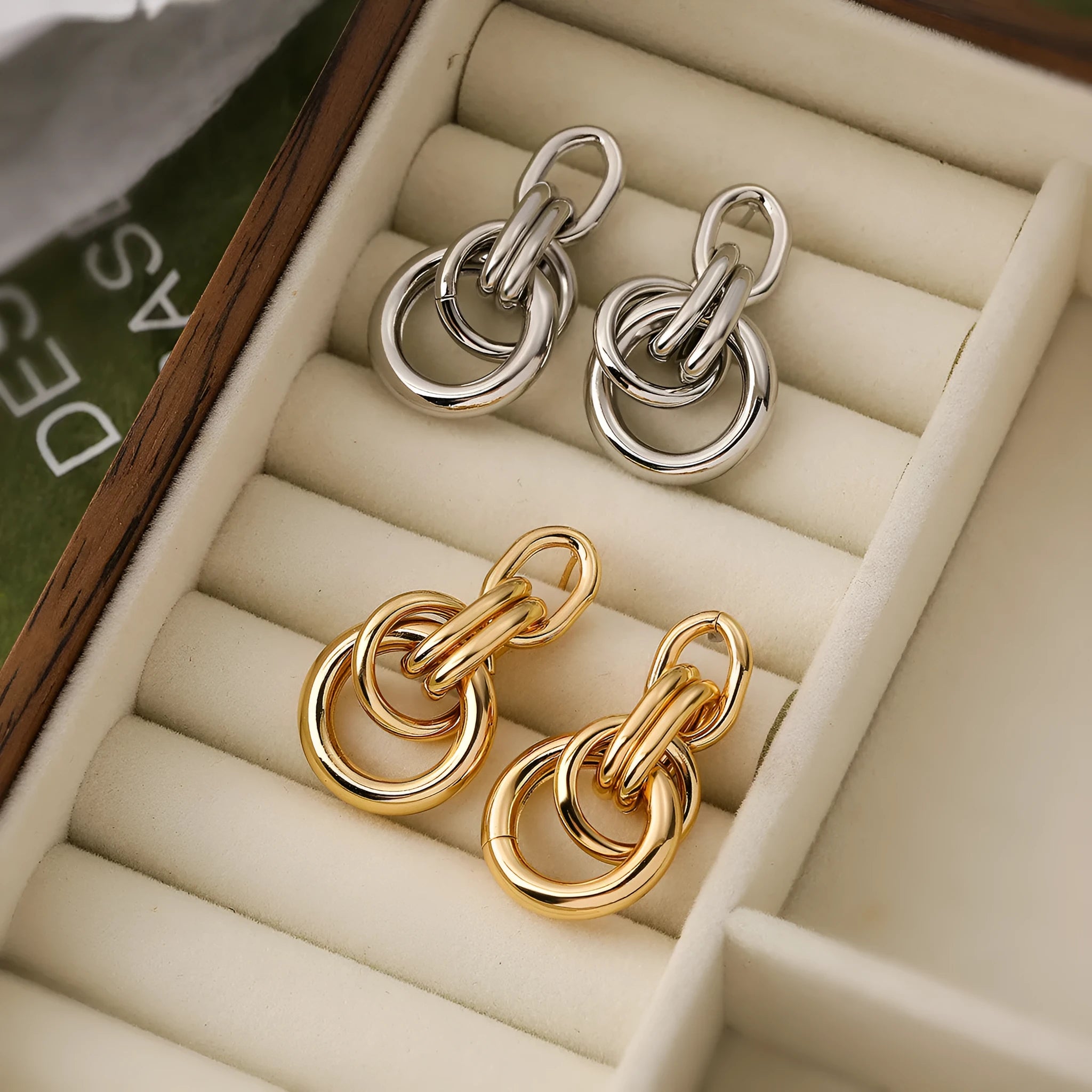 Gold geometric drop earrings with irregular design elements on copper base