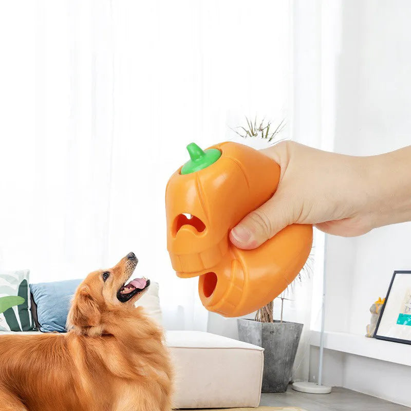 Orange Halloween pumpkin shaped dog chew toy with treat dispensing openings
