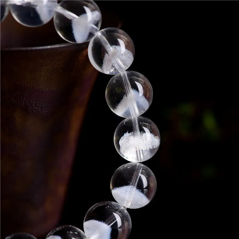 Women's original white crystal pyramid bracelet with ruyi charm, showing polished beads.