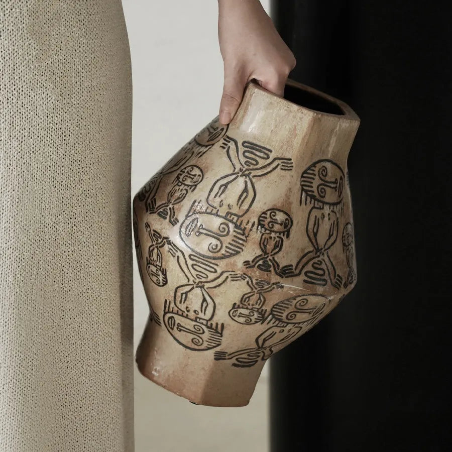 Hand-painted cylindrical ceramic vase with vintage carved tribal totem patterns in high or low style.
