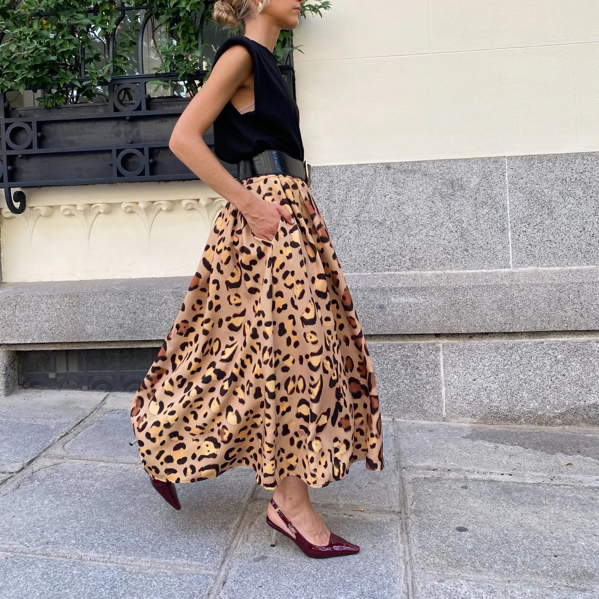 Brown leopard print women's A-line long skirt with a flared big hem, shown on a model.