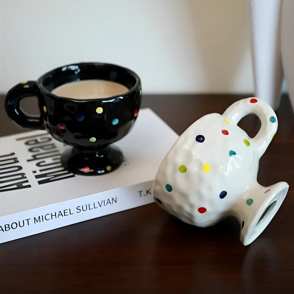Handmade irregular solid colour ceramic mug on a table, showing its unique shape.