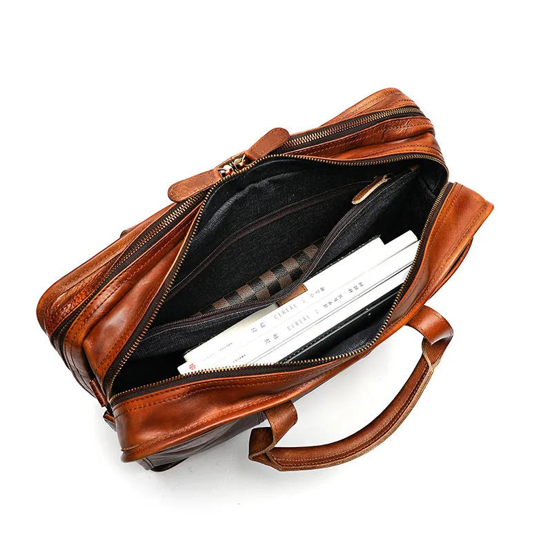 Vintage style brown leather men's briefcase showing internal organisation pockets and soft handle.