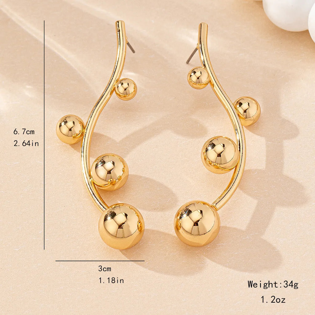 Pair of golden yellow round ball stud earrings made from iron in a popular size