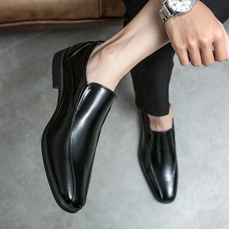 Men's black patent leather pointed toe shoes with a flat rubber sole and leather lining.