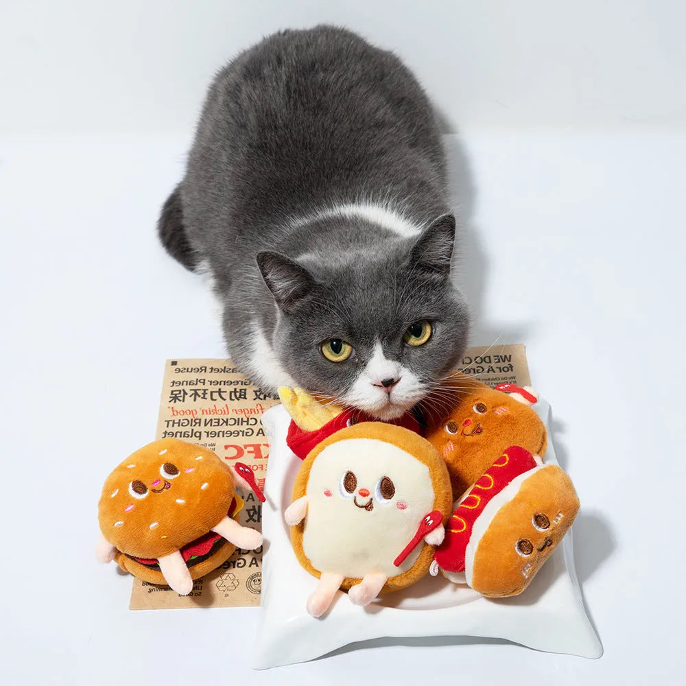 Cat chewing toy shaped like hamburger and chicken leg with catnip filling