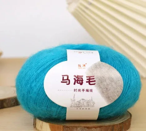 Ball of mohair yarn for DIY scarf knitting in one of 34 colours, including white, pink, blue, and green.