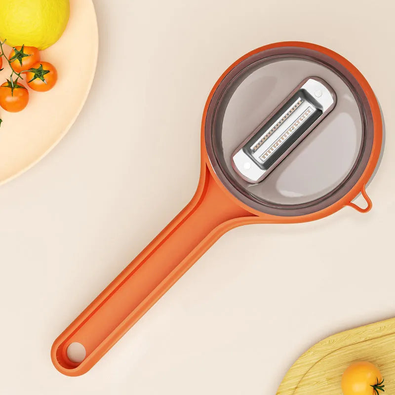 Kitchen storage peeler with integrated bucket in light green or orange colour