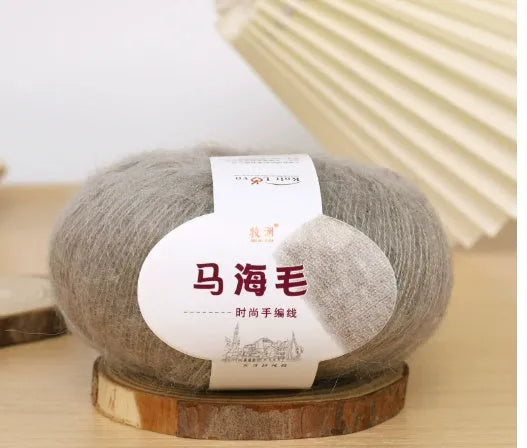 Ball of mohair yarn for DIY scarf knitting in one of 34 colours, including white, pink, blue, and green.