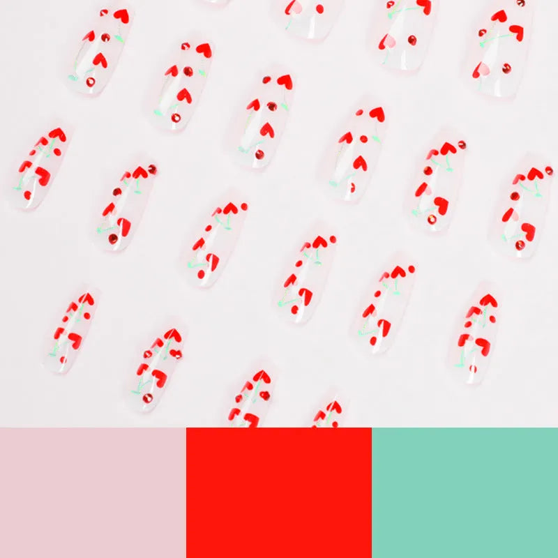Set of 24 red cherry and diamond shaped nail art decorations for French manicure designs.