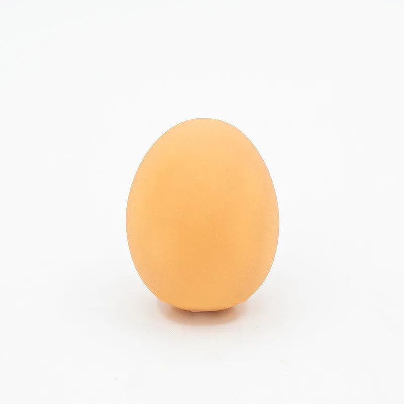 Red rubber egg-shaped dog chew toy with squeaker sound mechanism for dental care and interactive play.