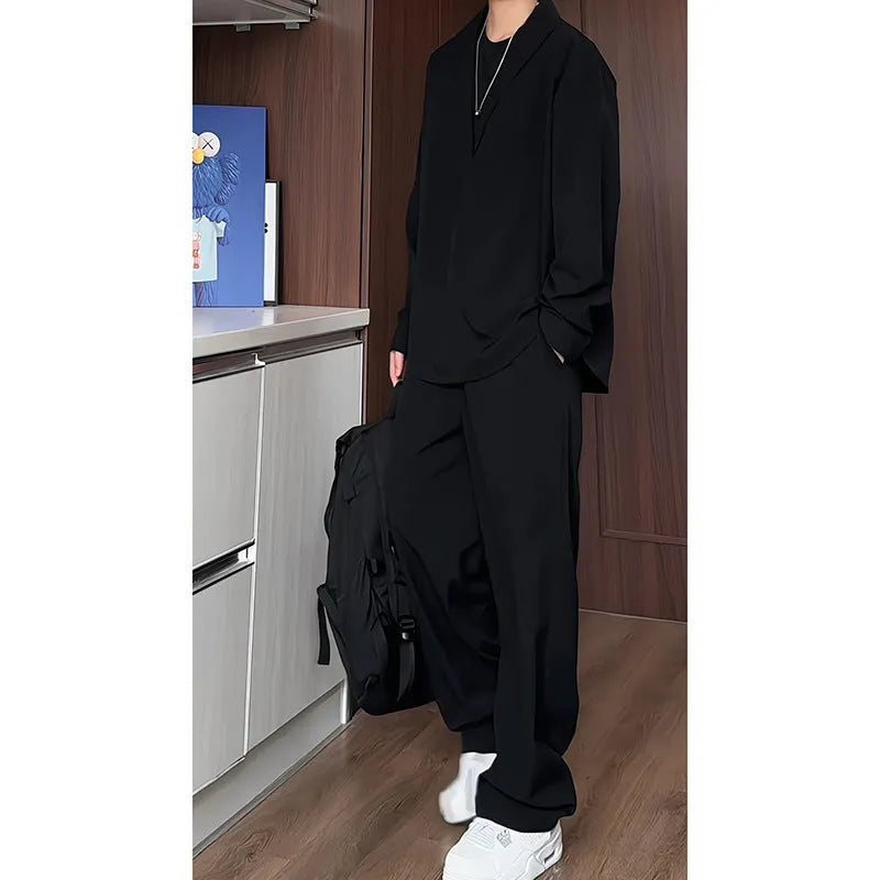 Men's black casual two-piece set with long sleeve polo shirt and trousers on a hanger