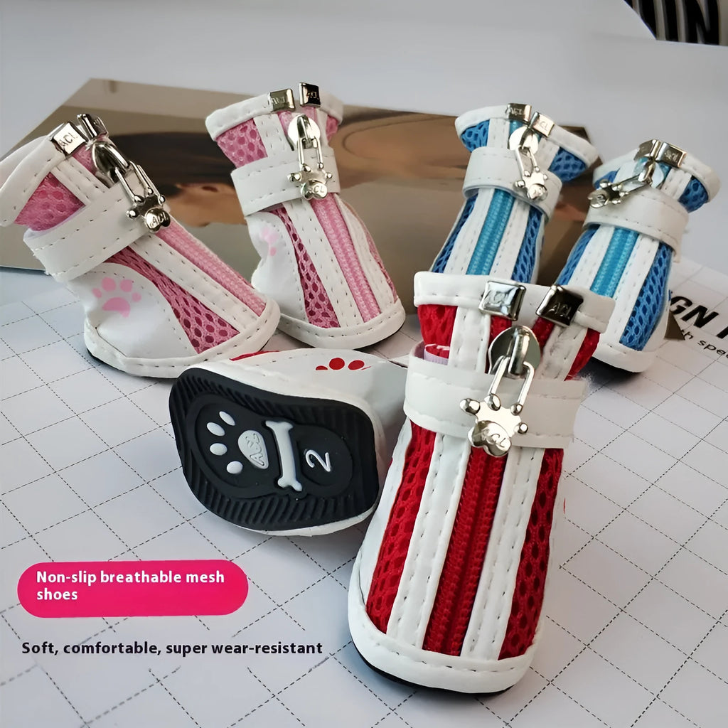 Four pairs of blue, pink, and red cloth dog shoes with zip fastenings on a white background.