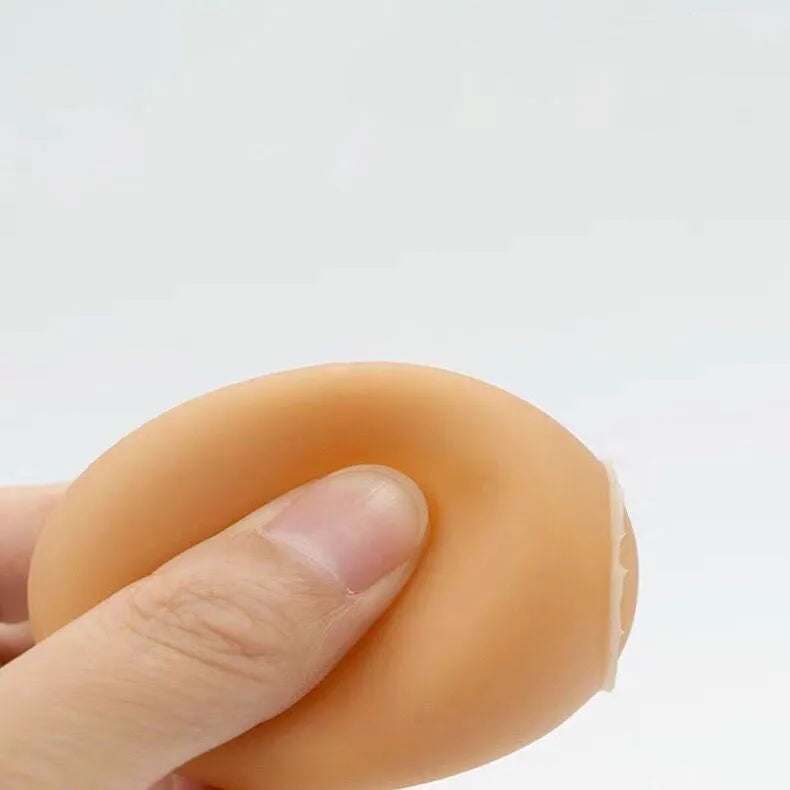 Red rubber egg-shaped dog chew toy with squeaker sound mechanism for dental care and interactive play.