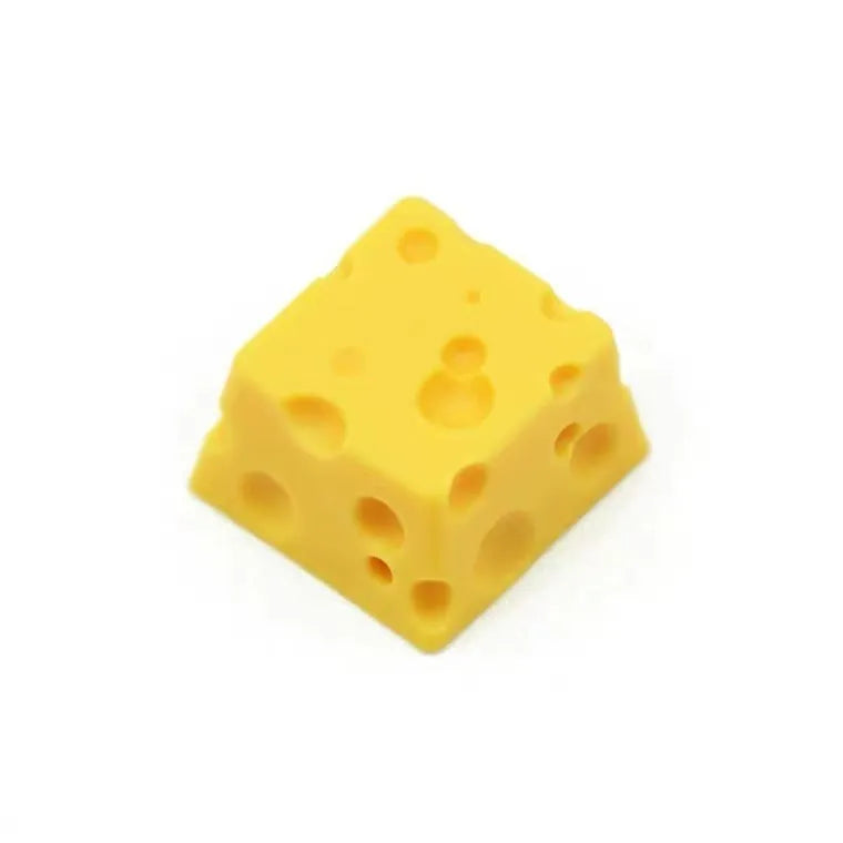 Yellow resin cheese character key cap for mechanical keyboards on a white background.