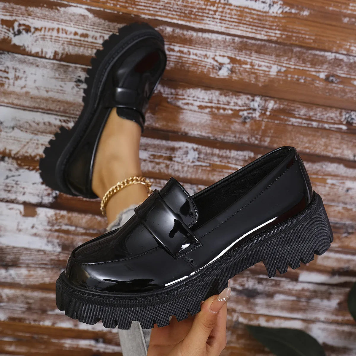 British-style slip-on loafers with a chunky mid heel and thick rubber platform sole.
