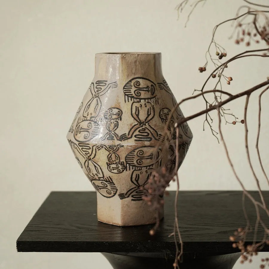 Hand-painted cylindrical ceramic vase with vintage carved tribal totem patterns in high or low style.