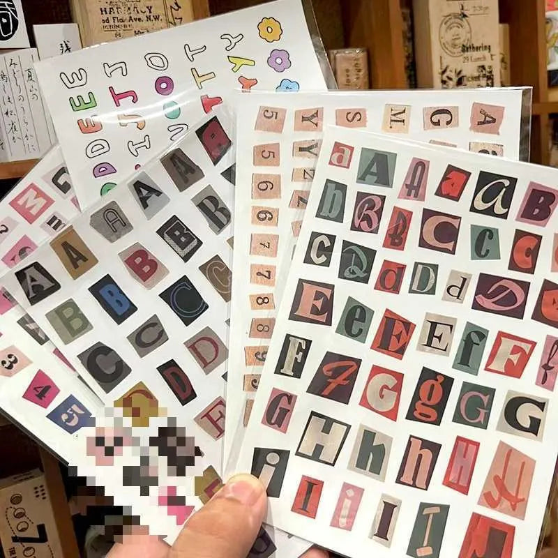 A4 sheet of colourful English alphabet, number, and word stickers in a cute style for decoration and organisation.