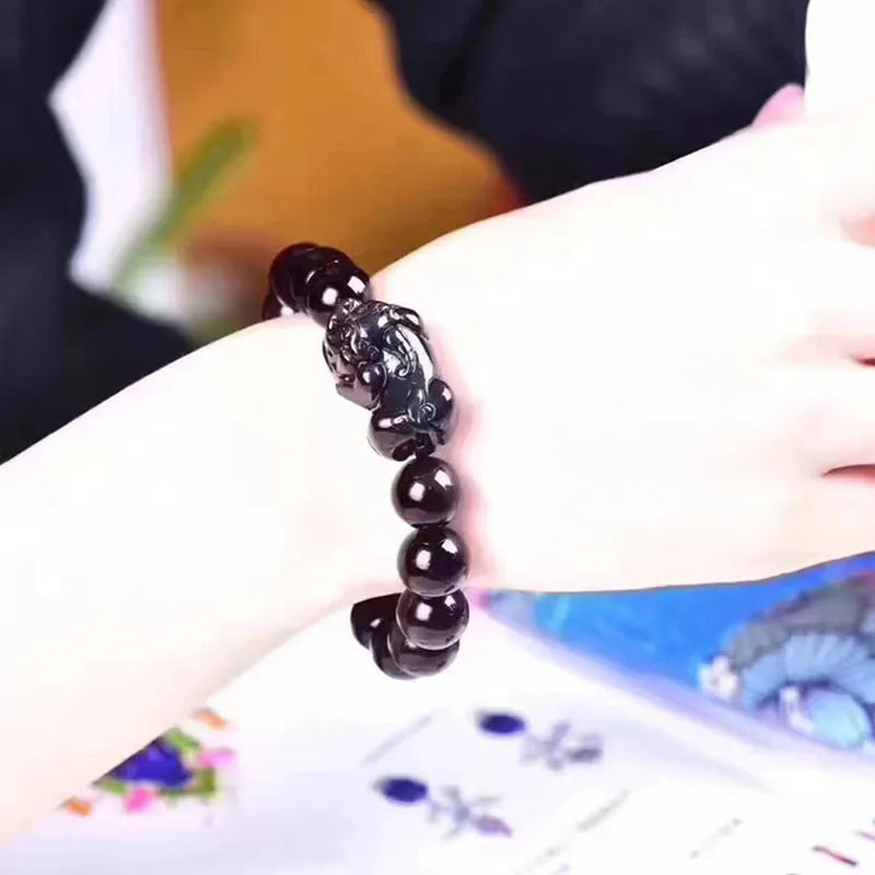 Natural ice colour eye obsidian crystal bracelet with spherical beads on a string.