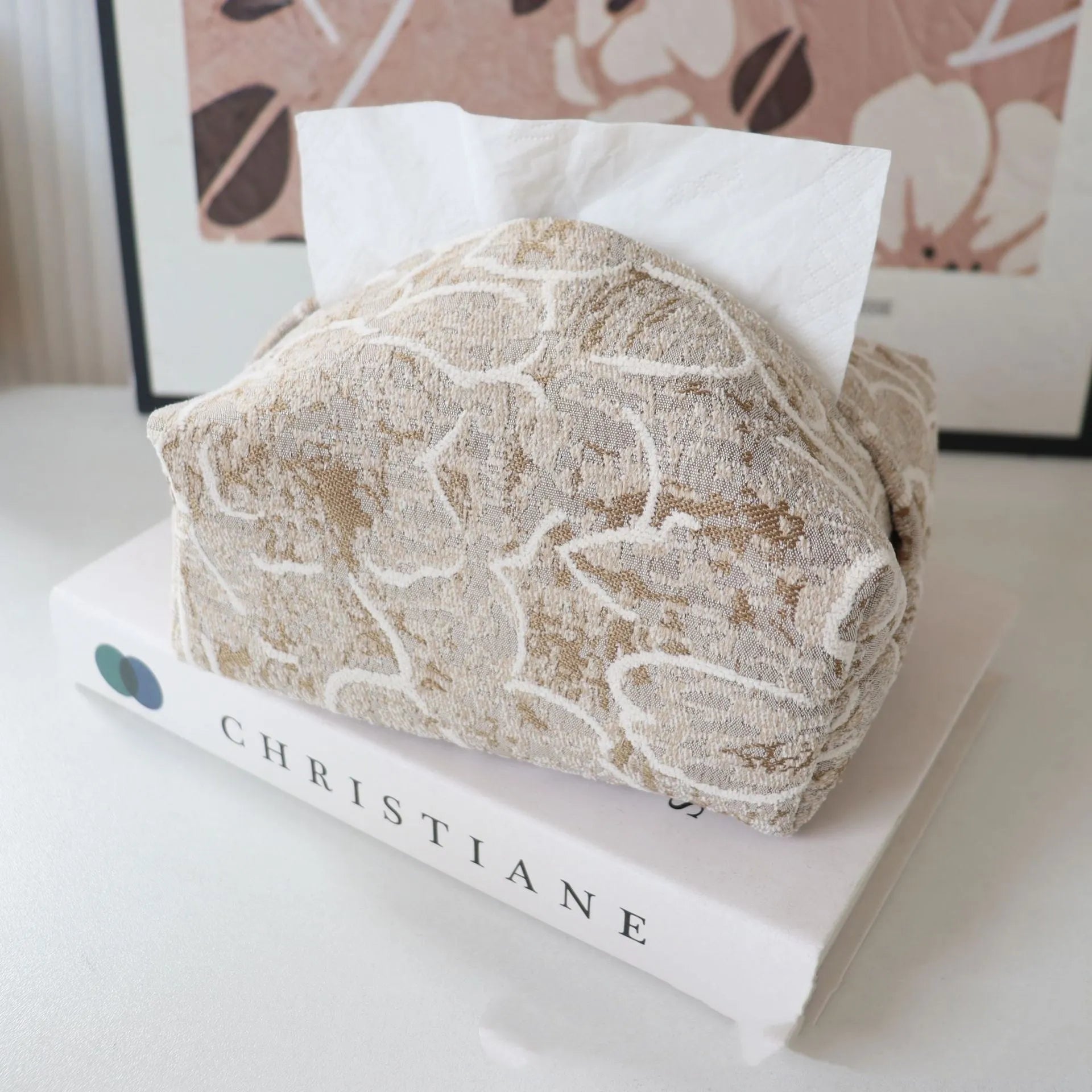 Chinese style floral cotton tissue box cover in beige, blue, and brown on a wooden table.