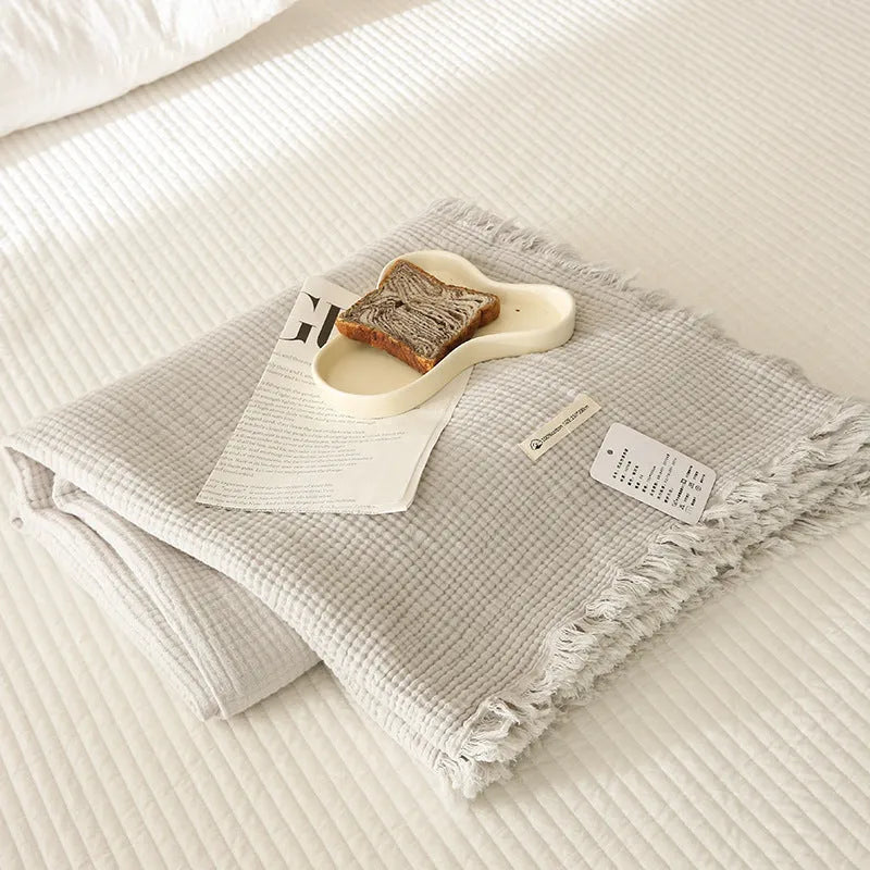Four-layer cotton gauze blanket with tassel trim in navy blue colour