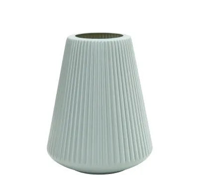 Colourful melamine plastic flower vase in blue, green, pink, or white on a desk.