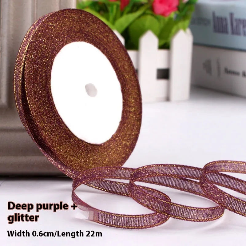 Roll of narrow 0.6cm wide polyester gift ribbon in a multicolour pattern.