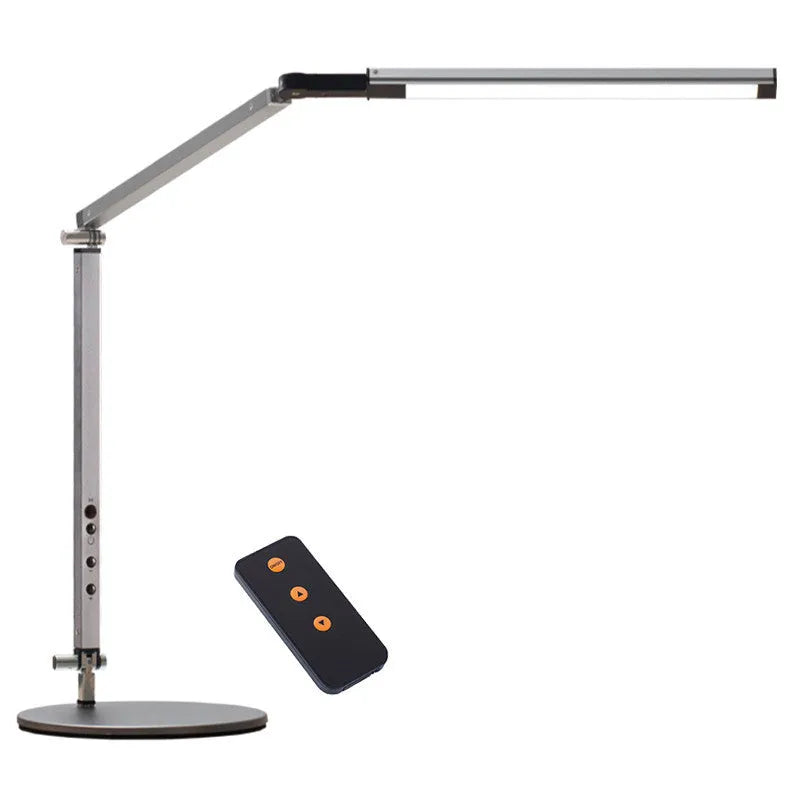 Adjustable LED desk lamp with clip attachment in black finish on wooden desk