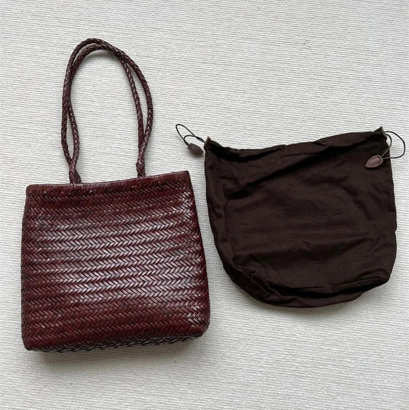 Brown handmade woven leather tote bag with a three-dimensional pocket.