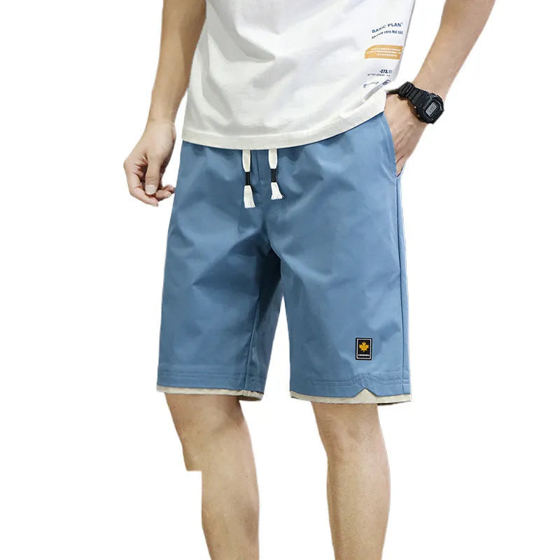 Korean style straight leg loose beach shorts in polyester, shown in green on a mannequin.