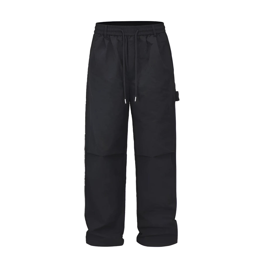 Black paratrooper pants with baggy fit and drawstring waist adjustment