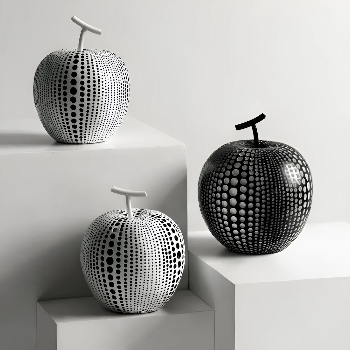 Resin apple and pear ornaments, black high model 17cm by 14cm and white low model 16cm by 12cm.