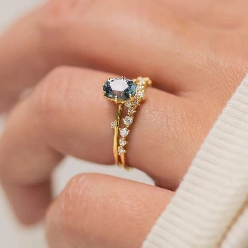 Gold plated women's ring with green zircon stone in floral design on model finger