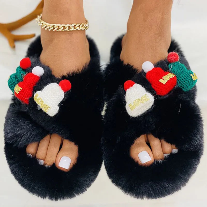 Women's festive slippers with a Christmas hat decoration on a faux plush upper.