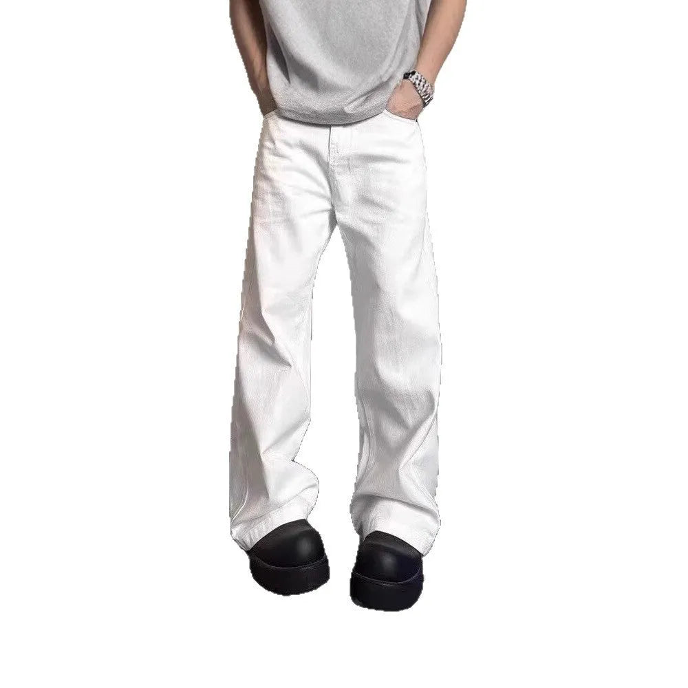 Man wearing white straight-leg cotton denim jeans with a wide leg opening.