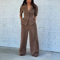 Brown men's slim fit suit with long sleeve top and trousers on a hanger.
