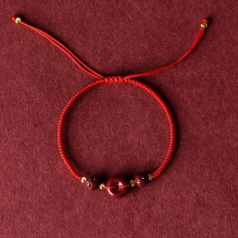 Cinnabar heart charm bracelet with adjustable red rope and traditional safety buckle in multiple colour options