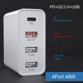 White and black multi-port fast charge USB wall charger with PD and QC support on a wooden surface.