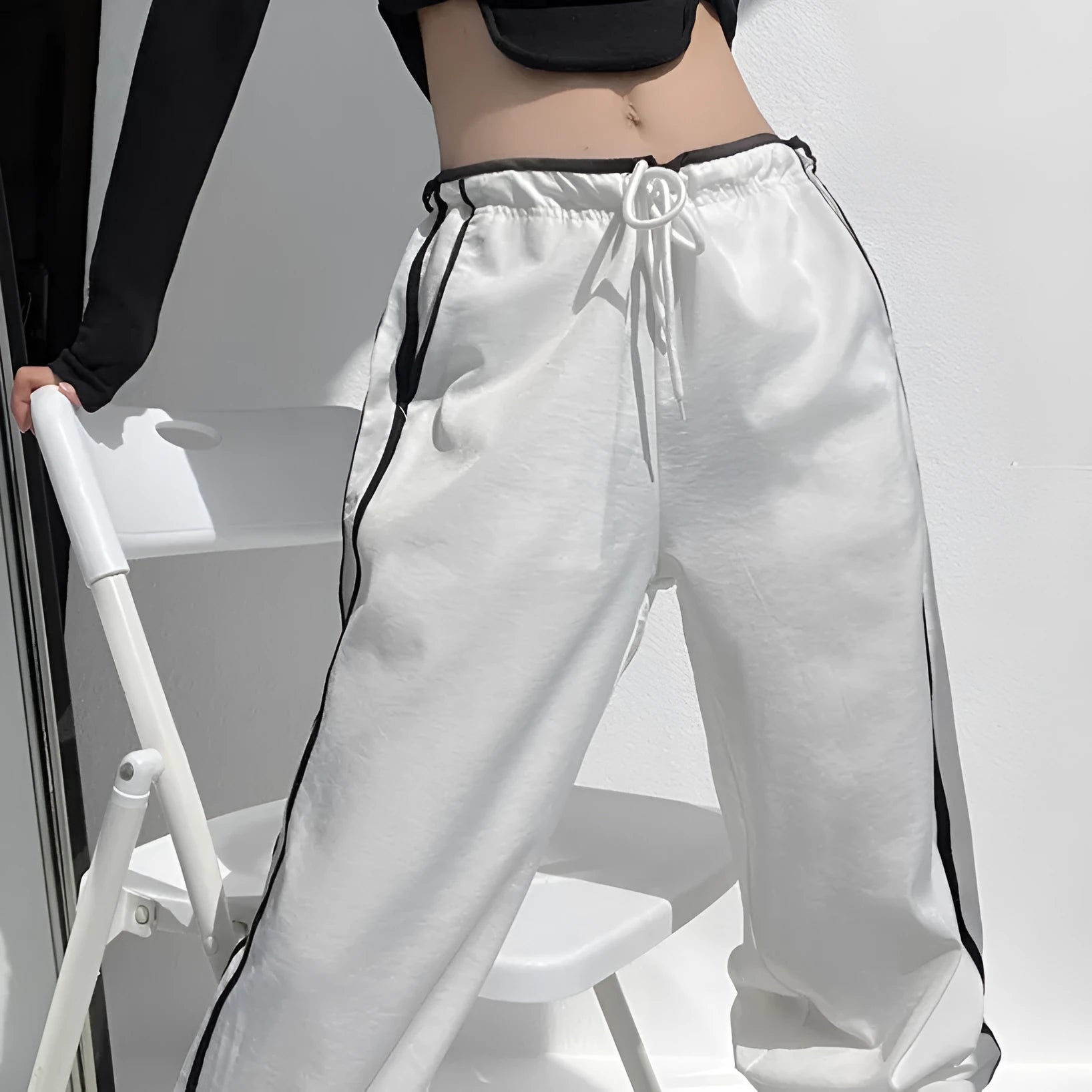 Women's navy blue straight-leg trousers with a white contrast ribbon detail sewn along the side seams.