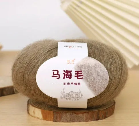 Ball of mohair yarn for DIY scarf knitting in one of 34 colours, including white, pink, blue, and green.