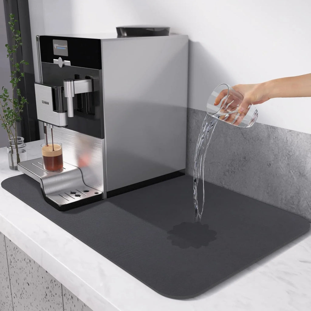 Black square kitchen drain drying mat with anti-slip rubber backing on a countertop