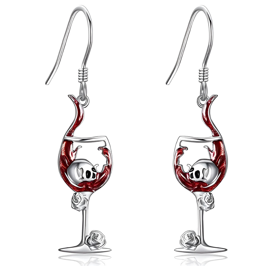 A pair of silver-toned drop earrings featuring a detailed geometry skull design combined with a wine glass shape.