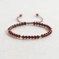 Simple geometric women's bracelet with natural freshwater pearls and crystal details on an elastic rope band.