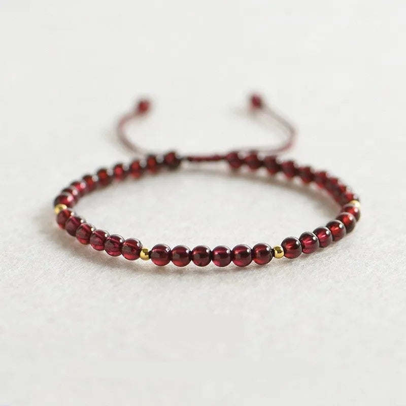 Simple geometric women's bracelet with natural freshwater pearls and crystal details on an elastic rope band.