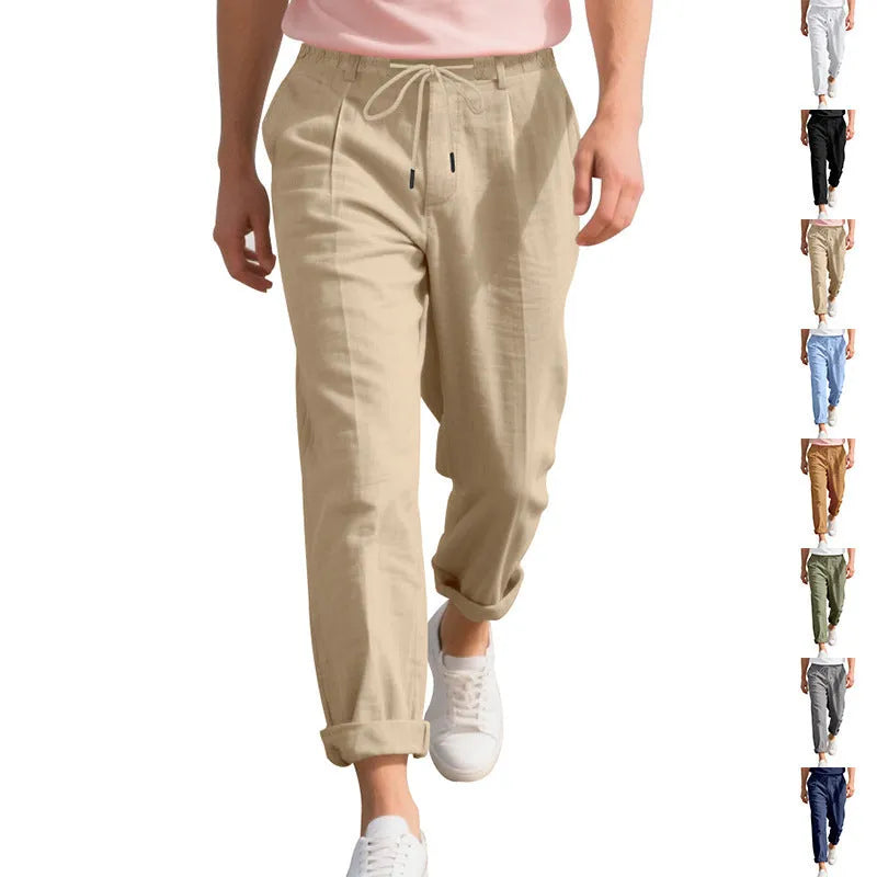 Man wearing light khaki linen casual trousers with a drawstring waist and straight-leg fit.
