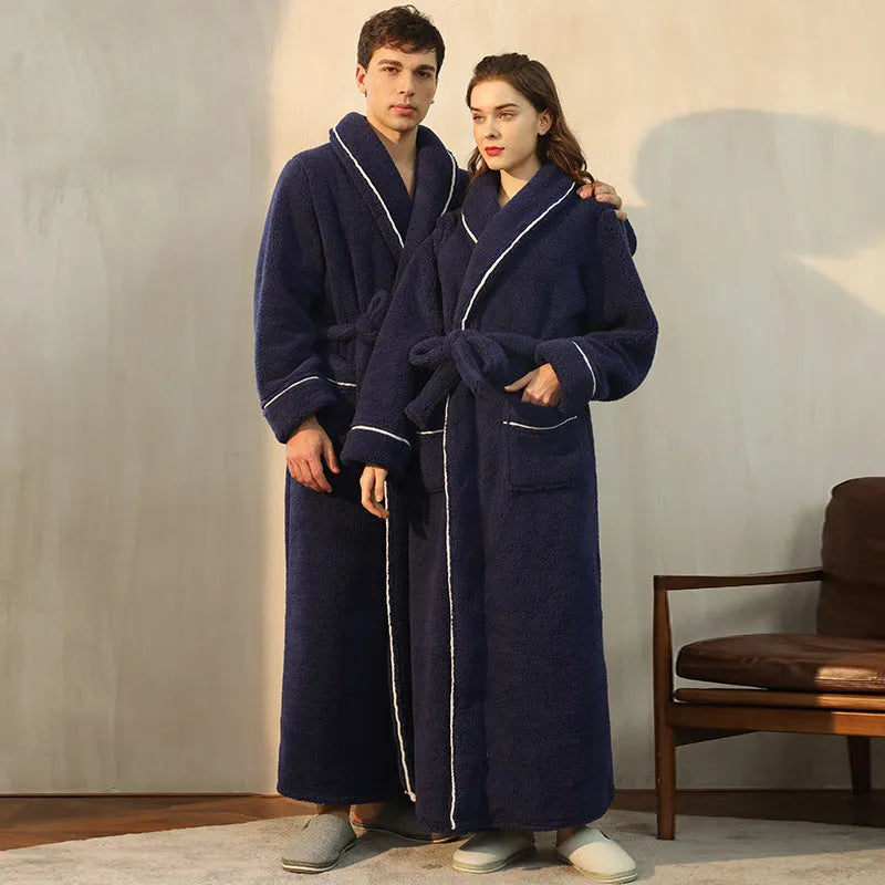 A man and woman wearing matching thick, navy blue flannel bathrobes in a European style cut.