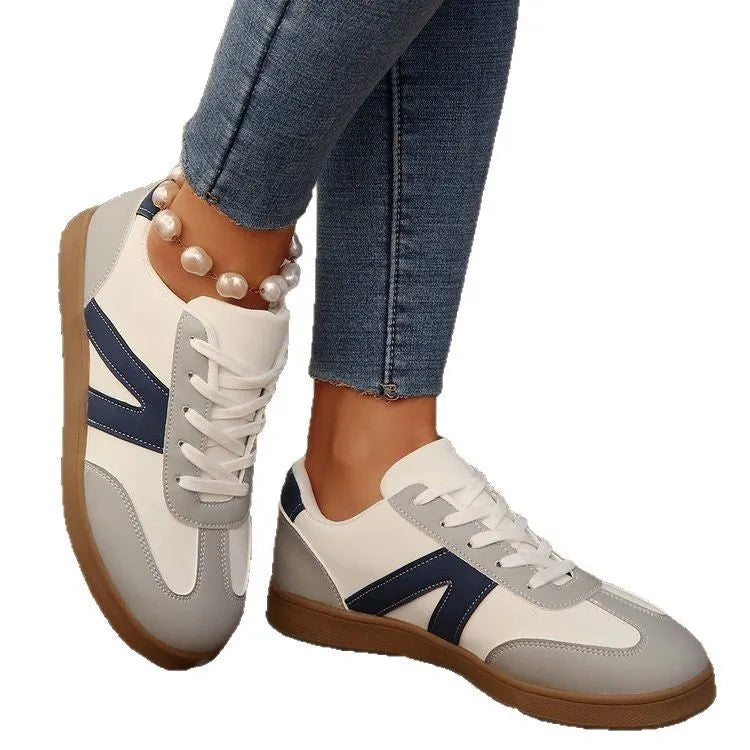 Blue women's low-top training shoes with rubber sole and front lace-up closure