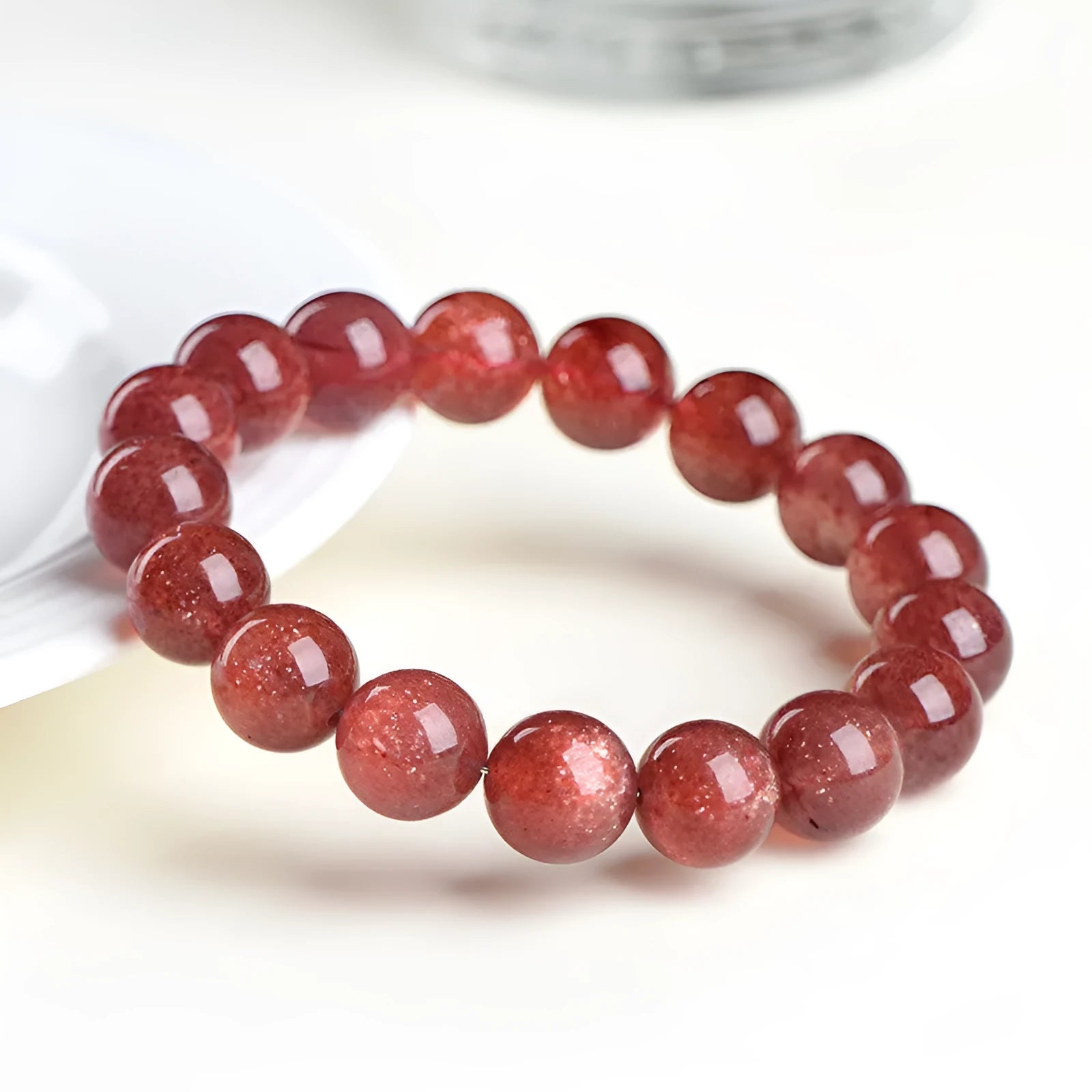 Natural cherry red strawberry quartz bracelet with geometric beads showing starlight effect