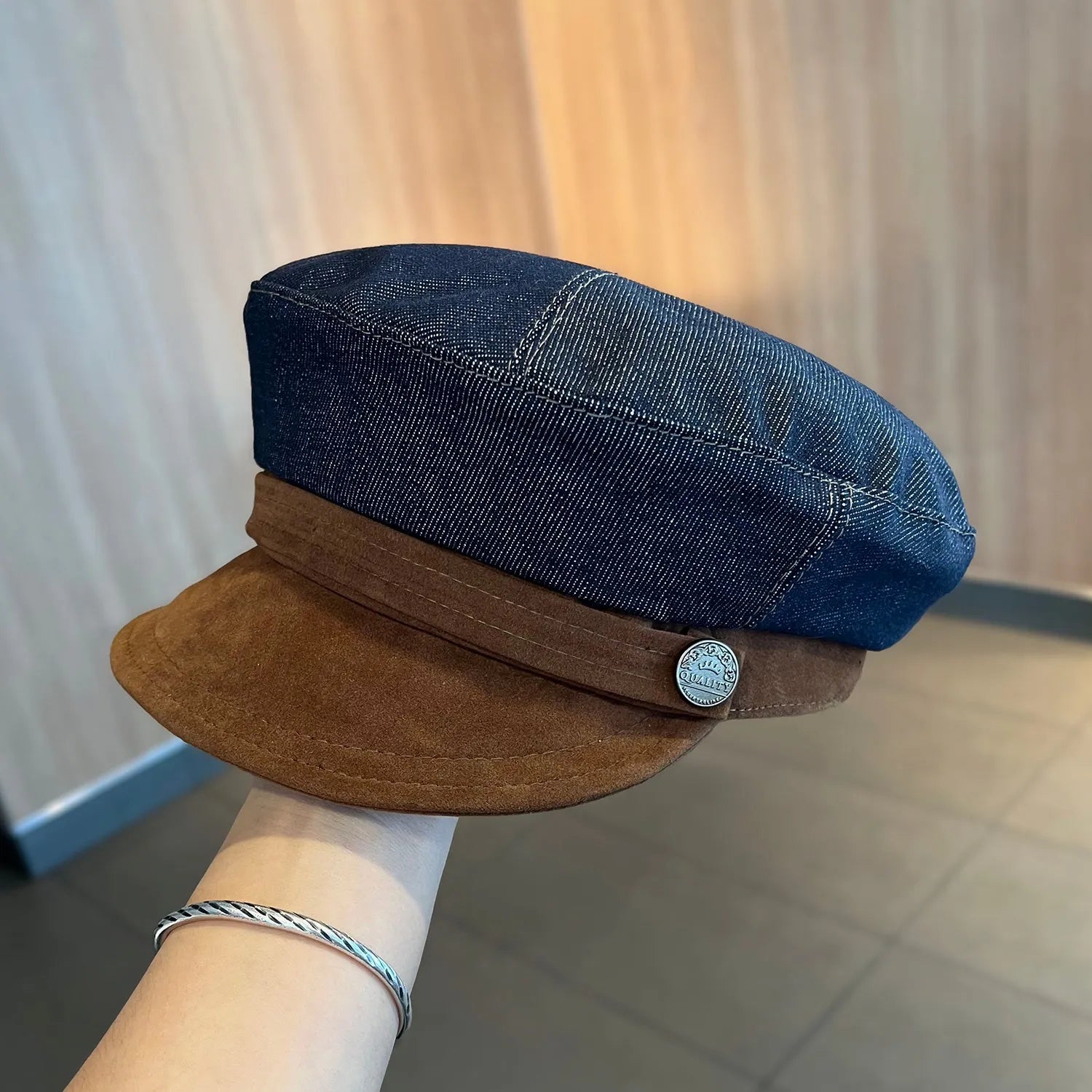 Dark blue denim newsboy hat with octagonal retro design and adjustable sizing